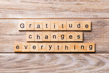 Gratitude changes everything word written on wood block. Gratitude changes everything text on wooden table for your desing, concept