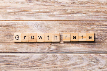 growth rate word written on wood block. growth rate text on wooden table for your desing, concept