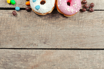 Glazed donuts on wooden background