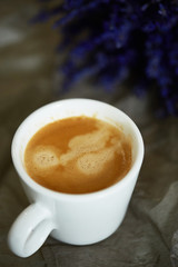 Obraz na płótnie Canvas cafee in white cup with lavanda