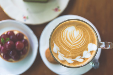 Cup of Latte on the table in coffee shop background