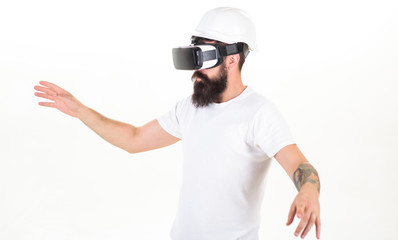 Portrait of bearded male in a white T-shirt with virtual reality glasses on his head isolated on white background. The man with glasses of virtual reality. Young man using a virtual reality headset.