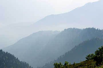 the majestic Caucasus mountains in the tonal perspective, and in the rays of the July sun and the outgoing