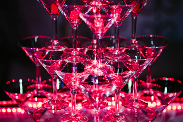 Glasses with alcoholic cocktails are beautiful slide beautifully illuminated in the bar.
