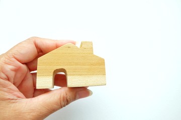 Close up of mini house on woman hand and white background