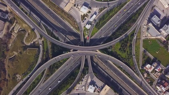 Aerial drone video of highway multilevel junction road, passing through city center