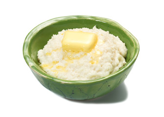 Rice porridge for breakfast with butter in a green bowl.