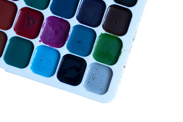 multi-colored watercolor paints for drawing close-up on white background