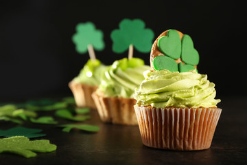 Tasty cupcakes and clover on table. Saint Patrick's Day celebration