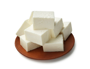 Plate with tasty feta cheese on white background