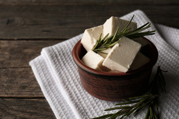 Bowl with tasty feta cheese on table