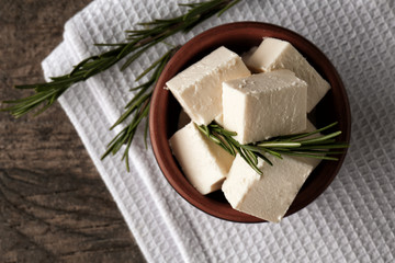 Bowl with tasty feta cheese on table