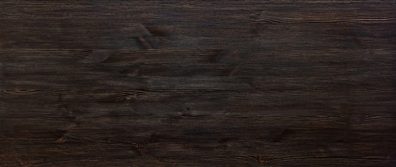 Dark brown painted wooden desk background tabletop wide horizontal photo banner for website design, black blank rustic wood texture timber board surface empty table header with copy space, top view