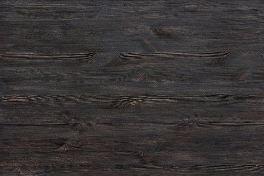 Dark brown painted wooden desk background tabletop, rustic rough old black blank rustic wood texture timber board surface empty table structure floor plank pattern with copy free space, top view