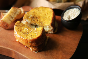 Sandwich made of tasty garlic bread on table