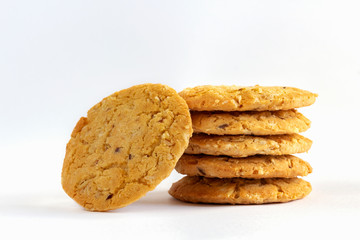 Homemade oat cookies stacked on white table background. Its are a nutrient-rich food associated with protein and fiber.