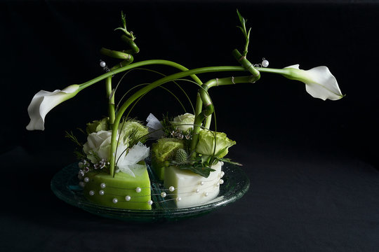 Flower arrangement with arums in a black background