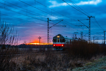 Fototapeta na wymiar Morning train at beautiful sunrise in Finland
