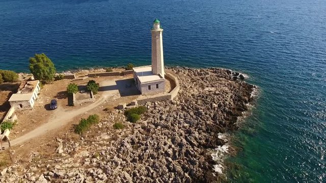 Aerial drone video of famous small islet of Kranai known for old lighthouse and tower of Tzannetakis, Gytheio, Lakonia, Peloponnese, Greece