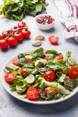 Fresh salad with tomatoes and quail eggs and lettuce.