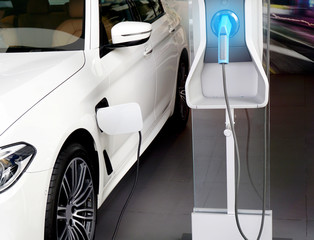 Power supply connect to electric car for add charge to the battery. Charging re technology industry...
