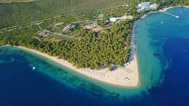 Aerial bird's eye view video taken by drone of exotic seascape and sandy beach with turquoise clear waters and pine trees, Gregolimano, North Evoia island, Greece