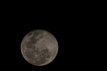First moon after the full moon with distinct craters visible on the upper edge