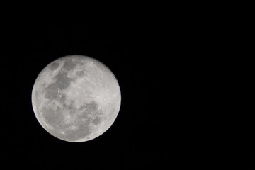 First moon after the full moon with distinct craters visible on the upper edge