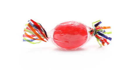 Colorful hard candy in transparent cellophane wrapping, isolated on white background