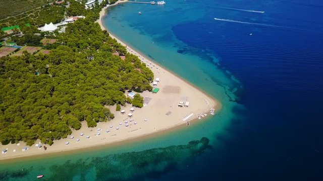 Aerial bird's eye view video taken by drone of exotic seascape and sandy beach with turquoise clear waters and pine trees, Gregolimano, North Evoia island, Greece