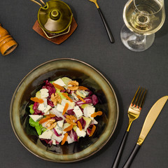 Fresh green salad with blue cheese, dried fruits and nuts. Healthy green salad with blue cheese and walnuts