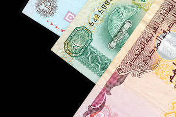 UAE dirham currency notes on a dark background close up