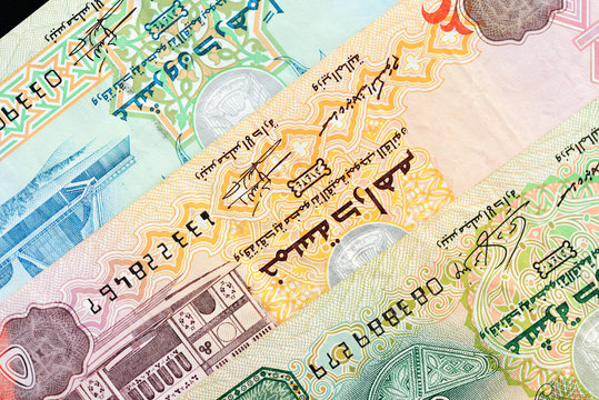 UAE dirham currency notes on a dark background close up