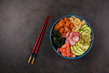 Hawaiian salmon poke bowl with seaweed, avocado, sesame seeds.