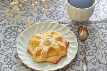 Cookie with pineapple on a white saucer on a white-gray background