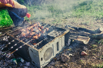 a picnic with a fire and a grill in the old computer case