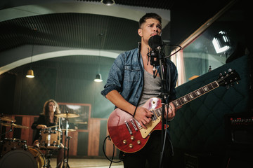 Fototapeta premium Music band having rehearsal in a studio