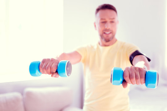 Beaming Bearded Man Leading Healthy Lifestyle Holding To Blue Hand Weights