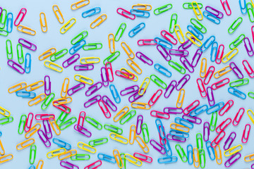 Paper color clip notebook on blue background. Flat lay.