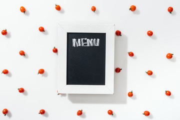 top view of chalk board with menu lettering among cherry tomatoes