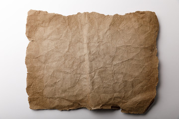 top view of old paper sheet lying on white background