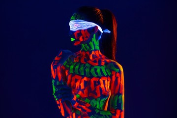Girl with beautiful UV bodyart profile shot