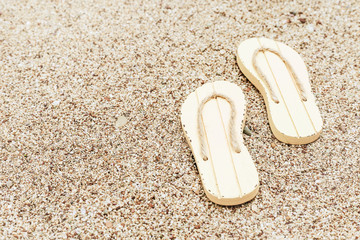 Beach flip flops on sandy beach. Summer concept. Fashion slaps. Copy space.
