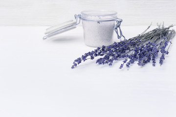 Spa background with dried lavender flowers and fragrant sea salt for bath and copy space.