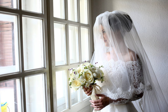 egant beautiful wedding bride posing near great window arch