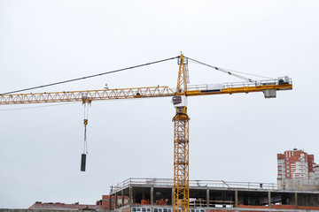 Fototapeta na wymiar the high crane at a construction site