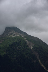 Obraz na płótnie Canvas Peaks of Dombai mountains in summer rain clouds