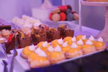 Delicious candy bar with macarons, cupcakes, cake pop and other sweets