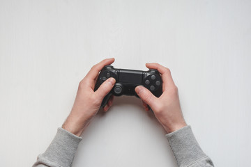 Hand hold new joystick isolated. Gamer play game with gamepad controller. Gaming man holding simulator joypad. Person with keypad joystic in arms. Sleeve hands hold toy equipment. Modern manipulator. © solidmaks