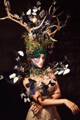 natural nymph with horns like branches of a tree and butterflies circling around. Fantasy style...